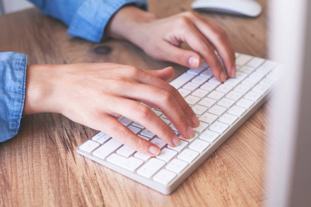 istock Hands of an office woman typing 1351002228