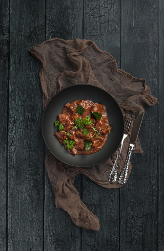Homemade Goulash beef stew plate served in rustic kitchen