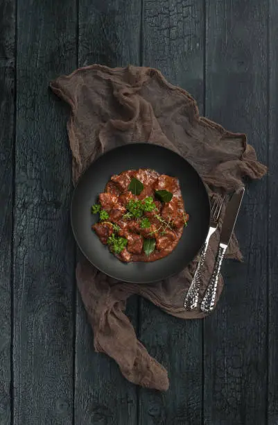 Homemade Goulash beef stew plate served in rustic kitchen