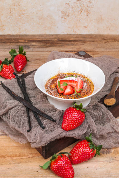 istock Creme Brulee Dessert with Vanilla and Strawberries in rustic kitchen 1351003033