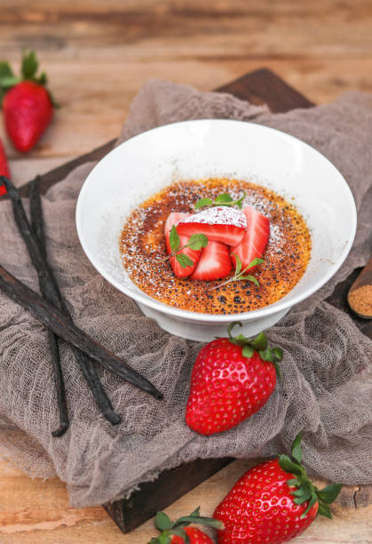 istock Creme Brulee Dessert with Vanilla and Strawberries in rustic kitchen 1351003052