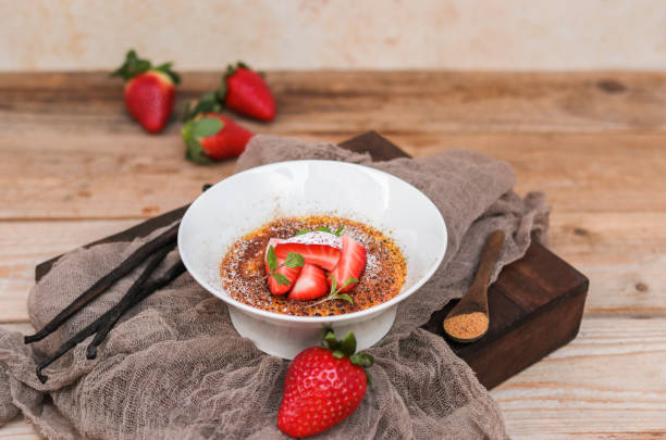 istock Creme Brulee Dessert with Vanilla and Strawberries in rustic kitchen 1351003082
