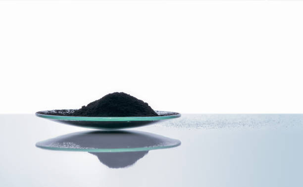 Carbon Charcoal Powder in Chemical Watch Glass. Close up chemical ingredient on white laboratory table. Side View Carbon Charcoal Powder in Chemical Watch Glass. Close up chemical ingredient on white laboratory table. Side View coke coal stock pictures, royalty-free photos & images
