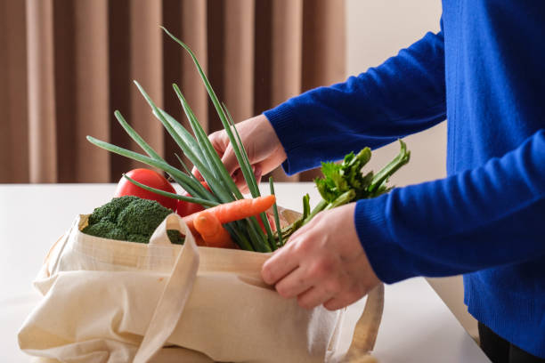 istock Vegetable shopping with reusable textile shopping bag 1351006309