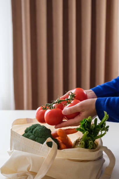 istock Vegetable shopping with reusable textile shopping bag 1351006324