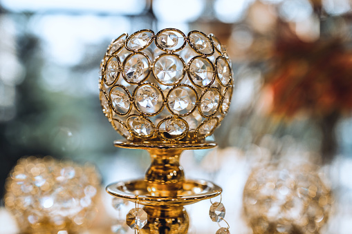 Close up image of crystal on chandelier with bokeh background