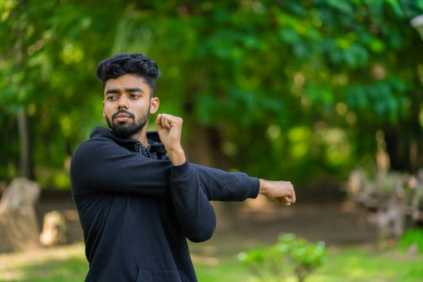 istock Young man stretches his arm, warming up before exercise 1351009415