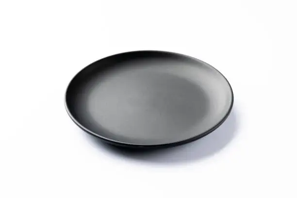 Photo of Black plate on white background