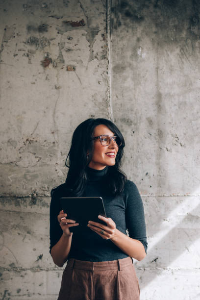 istock Portrait of a Beautiful Female Office Worker Using a Digital Tablet in the Office 1351009903