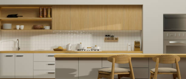 istock Mock-up space on wooden kitchen island with stools over minimalist kitchen background. 1351012815
