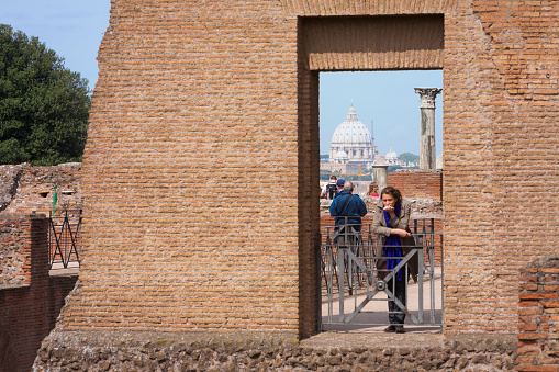 Roma. Panorama towards St Pietro' cupola from window of brick wall with tourists