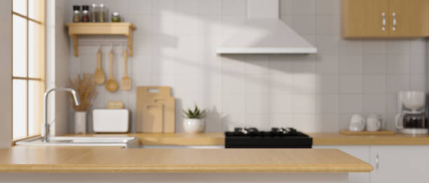 istock Modern luxury wooden kitchen island over blurred modern Scandinavian kitchen room 1351012871
