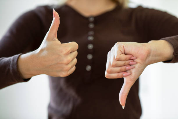 Giving thumbs up and down Giving thumbs up and down judgement stock pictures, royalty-free photos & images