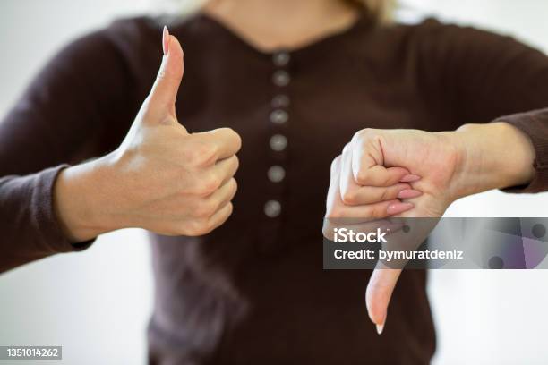 Giving Thumbs Up And Down Stock Photo - Download Image Now - Thumbs Up, Agreement, Judgement