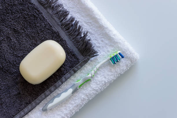 Hotel amenities set on a towel, including soap, toothbrush, and mouthwash as hospitality essentials.
