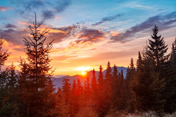 istock Sun hiding behind mountain range, beautiful sunset in the mountains 1351014920
