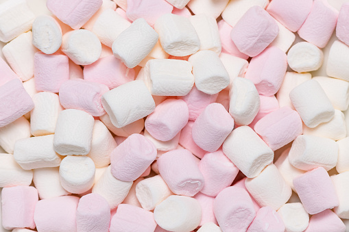 Sweet airy soft pastel pink and white marshmallows. Food background.