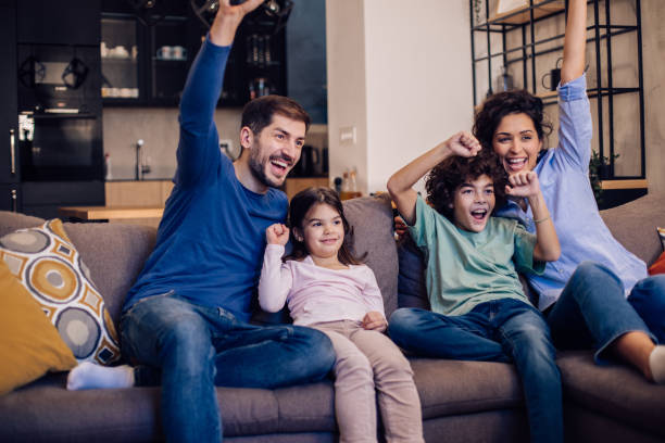 istock Family having fun watching TV in the evening 1351021955