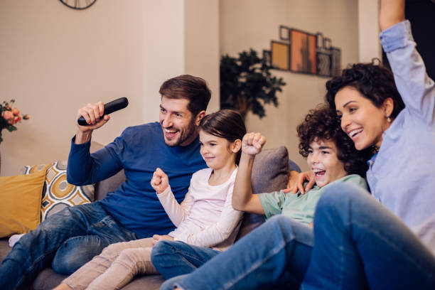 istock Parents and kids watching something fun on TV 1351021959