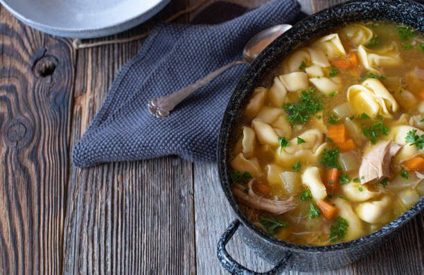 Pot with chicken noodle soup stock photo