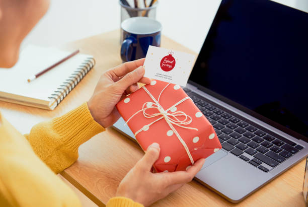 business woman holding giftbox and greeting card on office table in christmas day. - 2554 imagens e fotografias de stock