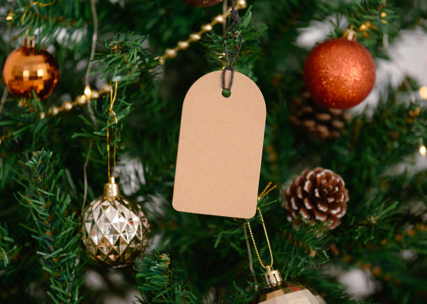 mockup christmas greeting tags on christmas tree background. stock photo
