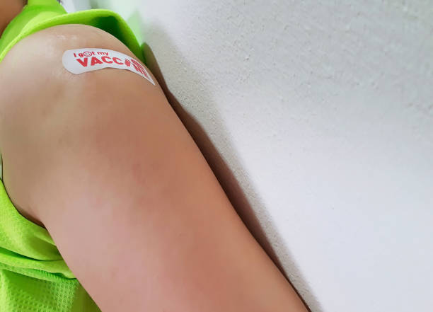 istock left arm with  white plaster red text i got my vaccine band-aid 1351025629