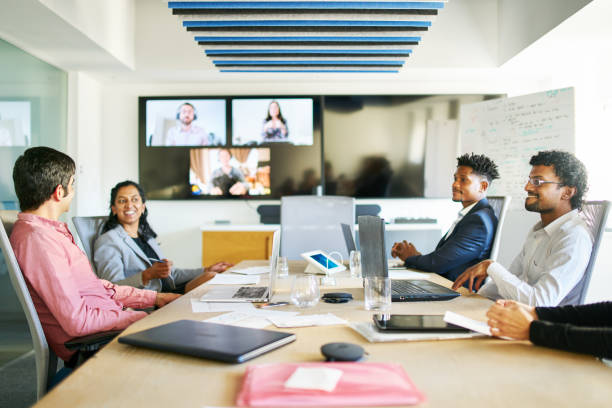 istock Smiling young businesspeople talking during a video conference call in a boardroom 1351025837