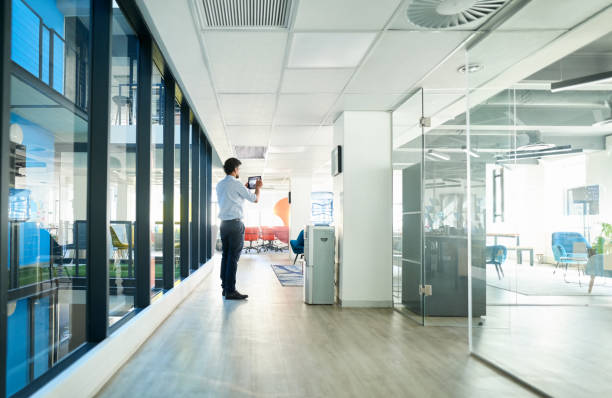 istock Real Estate Agent taking pictures of office space using digital tablet 1351025913