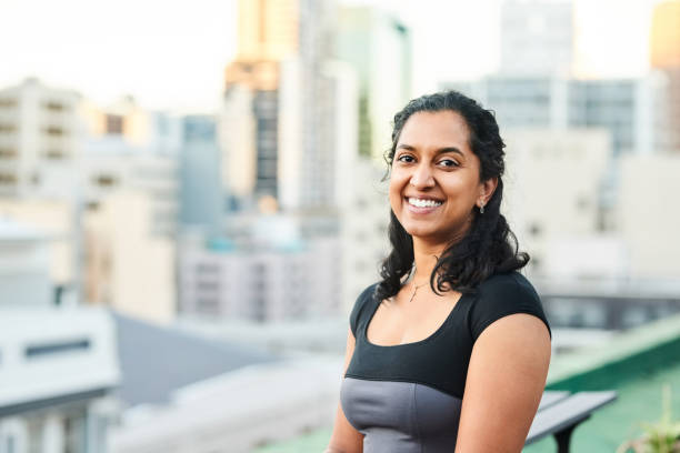 istock Happy young woman in office balcony 1351025952