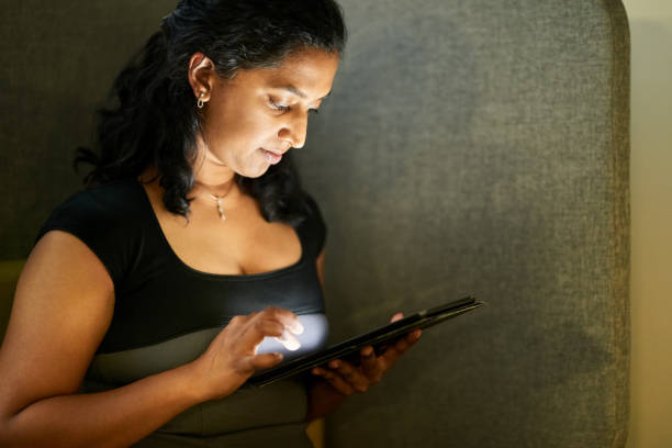 istock Woman surfing the net on digital tablet 1351026013