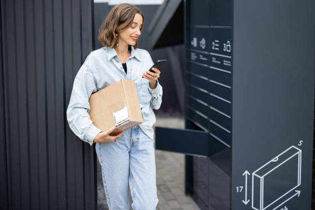 istock Caucasian woman with parcel near post terminal 1351027866