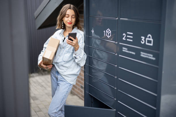 istock Caucasian woman with parcel near post terminal 1351027932