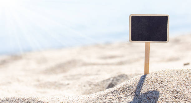 istock blank board sign on beach sand 1351027969