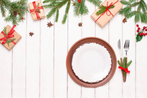 istock Christmas white background with Christmas table place setting decorations and Christmas gifts with copy space. 1351030821
