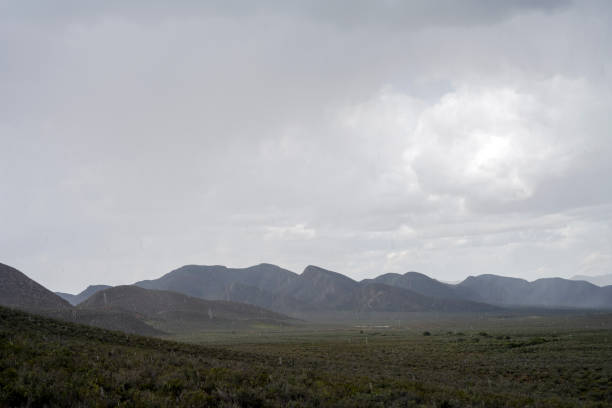Big waterdrops of rain falling in desert landscape