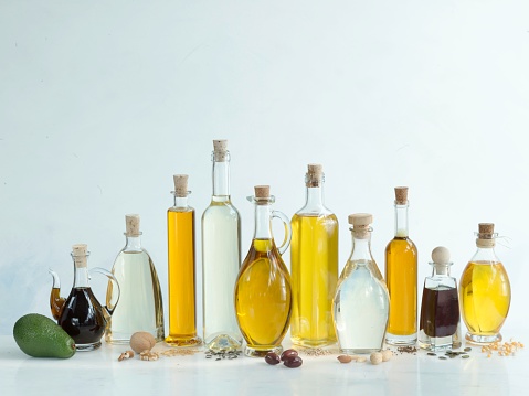 Various cooking oils: olive oil, peanut oil, corn oil, walnut oil, linseed oil, pumpkin seed oil, sunflower seed oil, sesame seed oil, coconut oil, avocado oil,