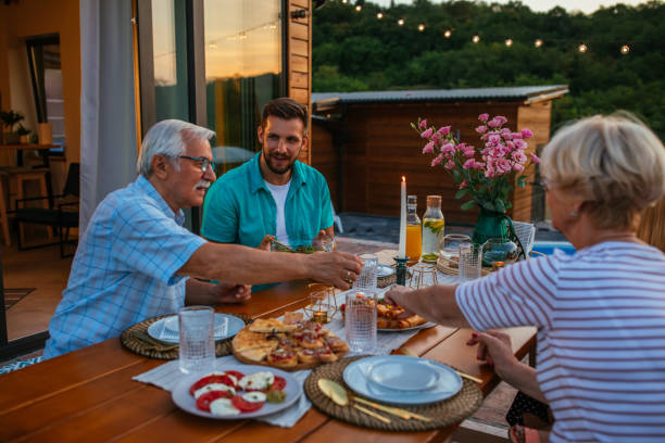 istock Family dinner around dining table in the garden 1351036492