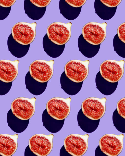 istock Pattern of ripe figs in a cut on a lilac background. 1351037895