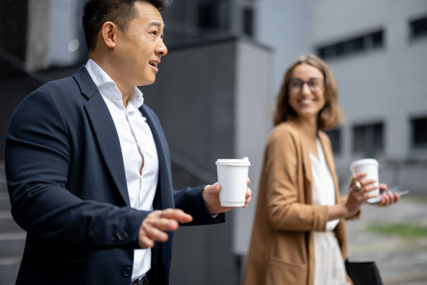 istock Business people walking and talking in city 1351038104