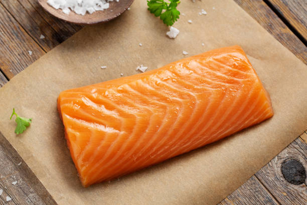 istock Raw salmon fillet on wooden background. 1351038995