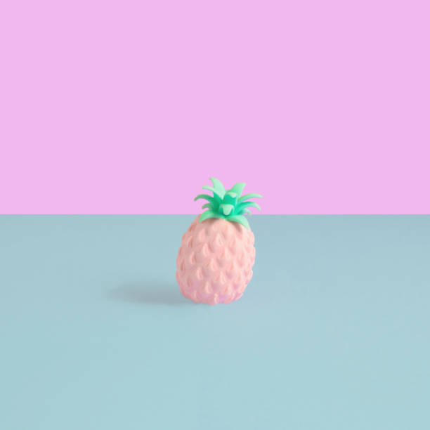 istock Colorful artificial pineapple stand on pastel pink and cyan background. Square composition, minimal summer decoration concept 1351039024