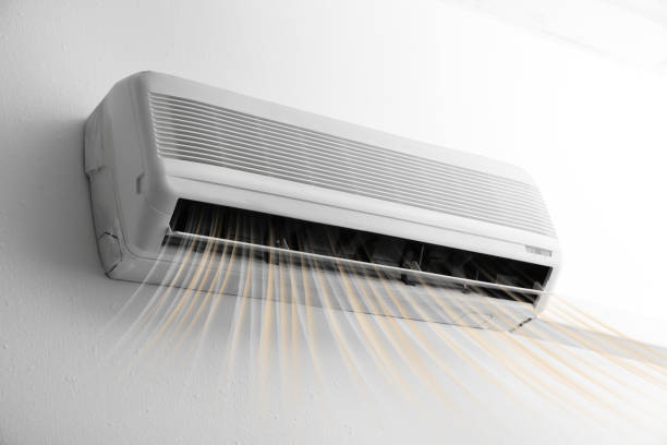 istock Modern air conditioner on white wall indoors 1351039233