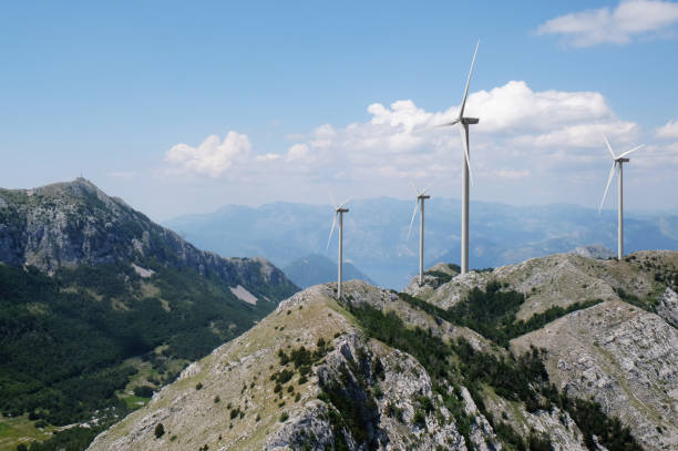 istock Alternative energy source. Wind turbines and mountains outdoors 1351039237