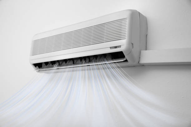 istock Modern air conditioner on white wall indoors 1351039540
