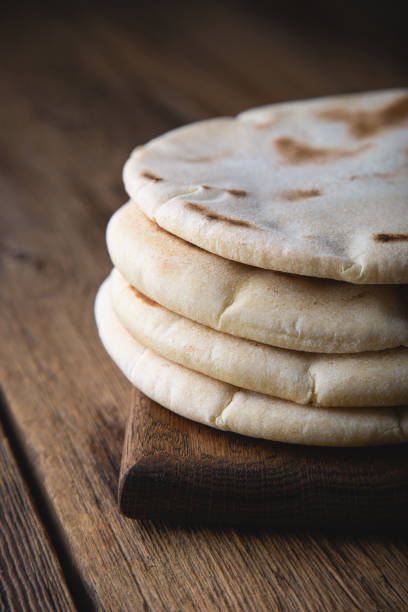 istock Fresh pita bread on a wooden table 1351039683