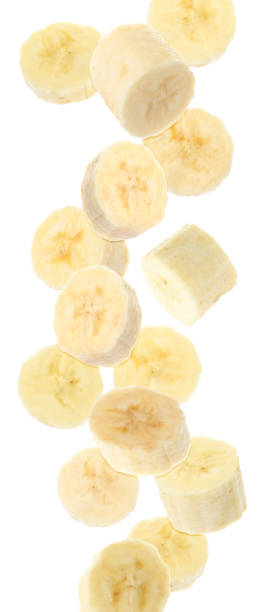 istock Set with delicious ripe banana pieces falling on white background 1351041951