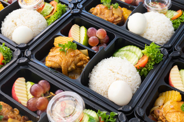 istock Thai food lunch boxes in plastic packages. Rice with Thai chicken massaman curry. 1351041990