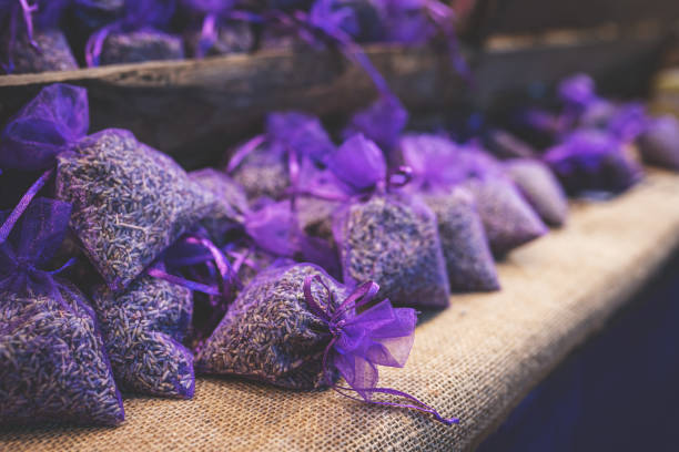 Lavender bud dry flower sachet fragrant bags, purple organza pouch with natural dried lavender flowers at market. Toned image with selective soft focus and copy space.