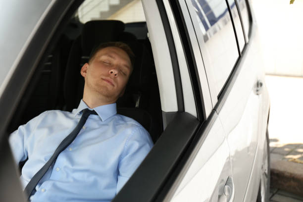 istock Tired young man sleeping in his modern car 1351042043